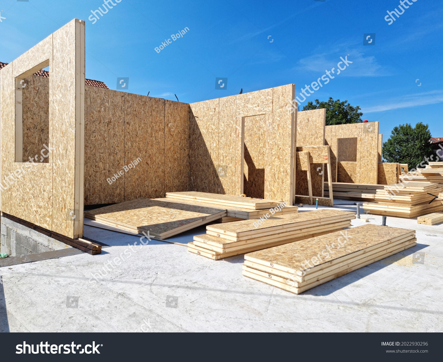 Construction of new and modern prefabricated modular house from composite wood panels. Energy efficient panel assembling #2022930296