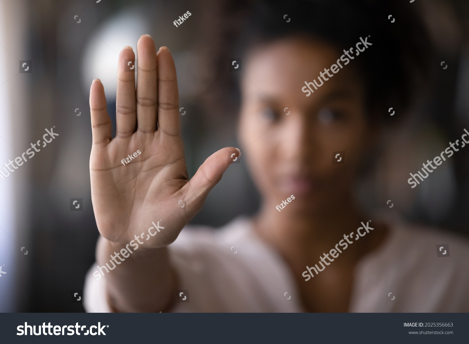 Crop close up focus of African American woman show palm hand against racial gender discrimination. Determined mixed race female make sign gesture protest against domestic violence or abortion. #2025356663
