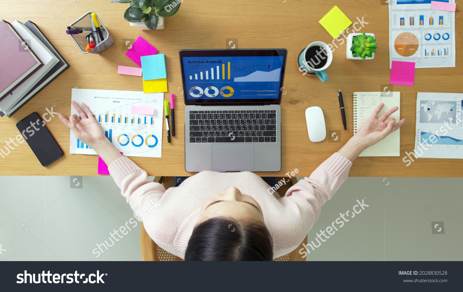 Above top view of asia girl work on desk table home office sit calm inhale deep stress relief in zen lotus yoga post. Good break rest time for teen labor people serene life in job career workforce. #2028830528