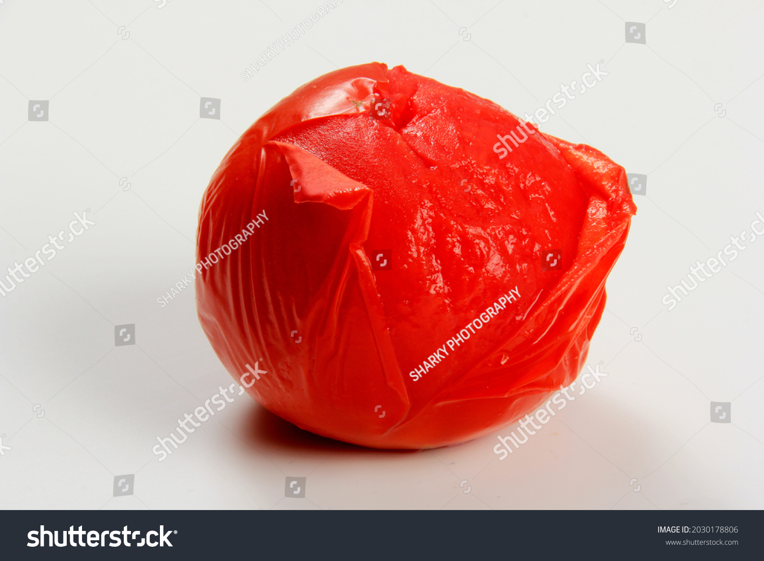 blanched red tomatoes on a white background, ready for peeling  #2030178806