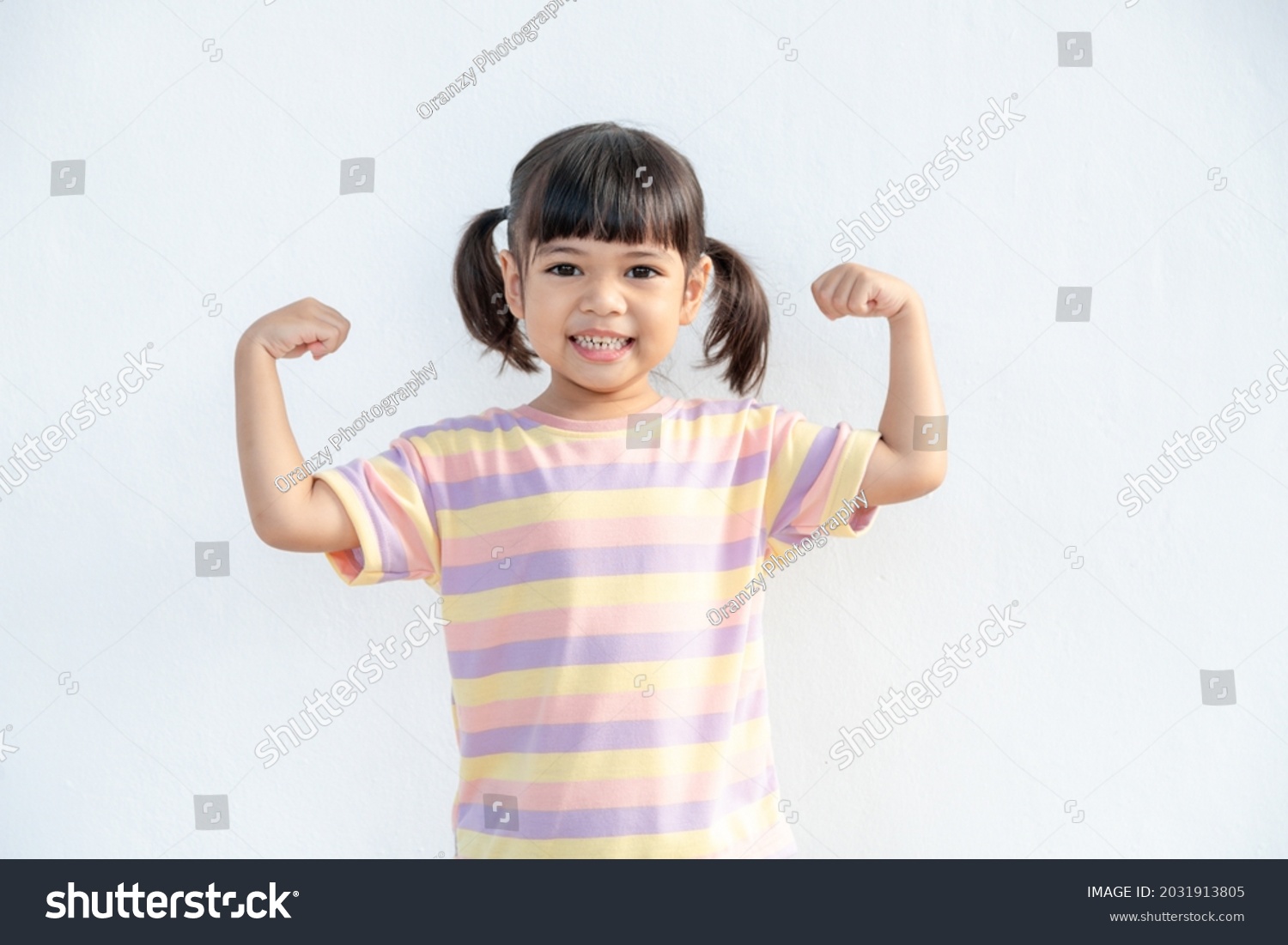Happy Asian children showing her strong hands #2031913805
