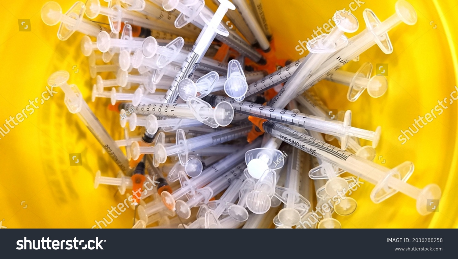 close up of the used vaccine needles in the sharp bin.  #2036288258