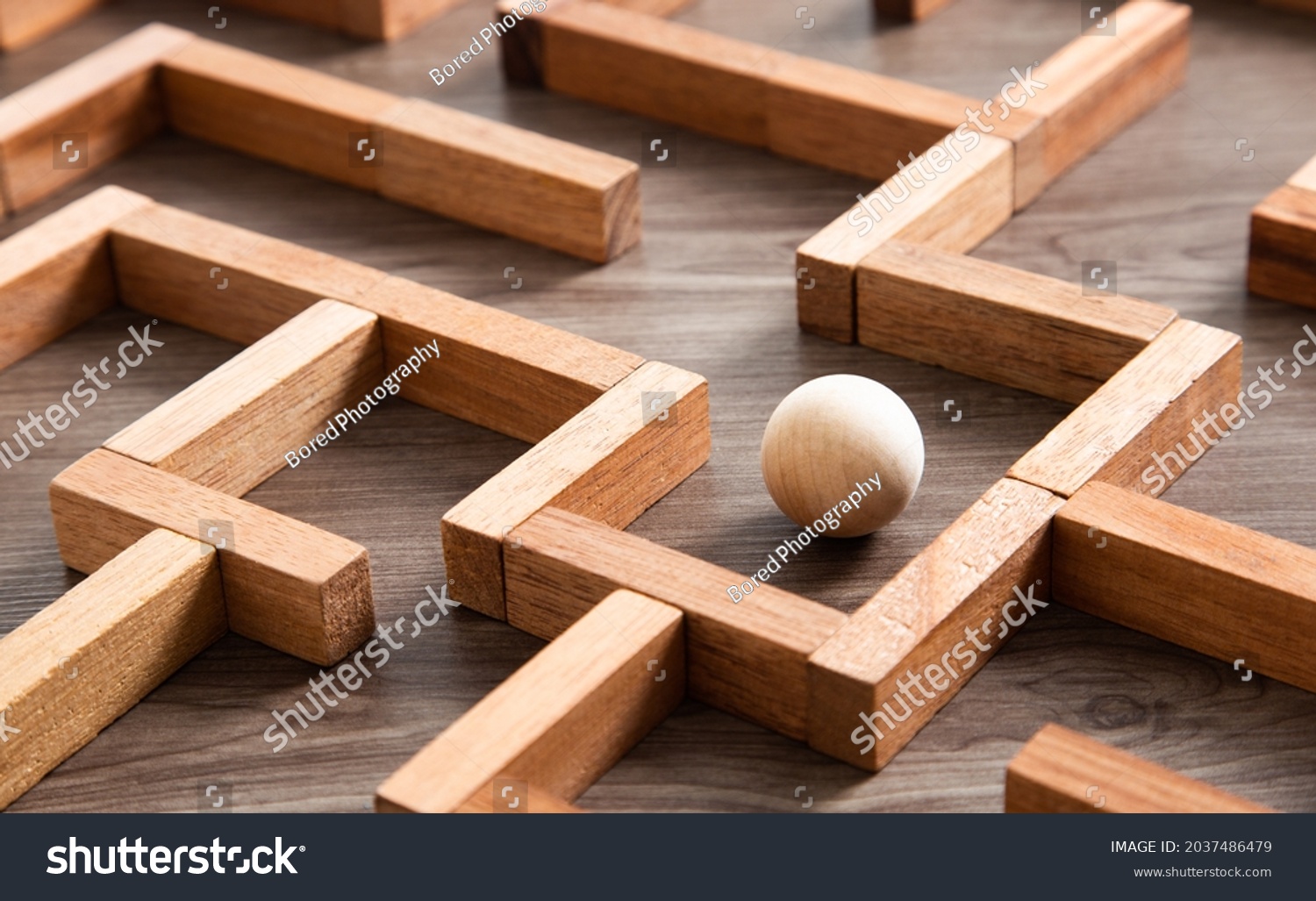 Wooden ball in a maze and thinking the best way to go. #2037486479