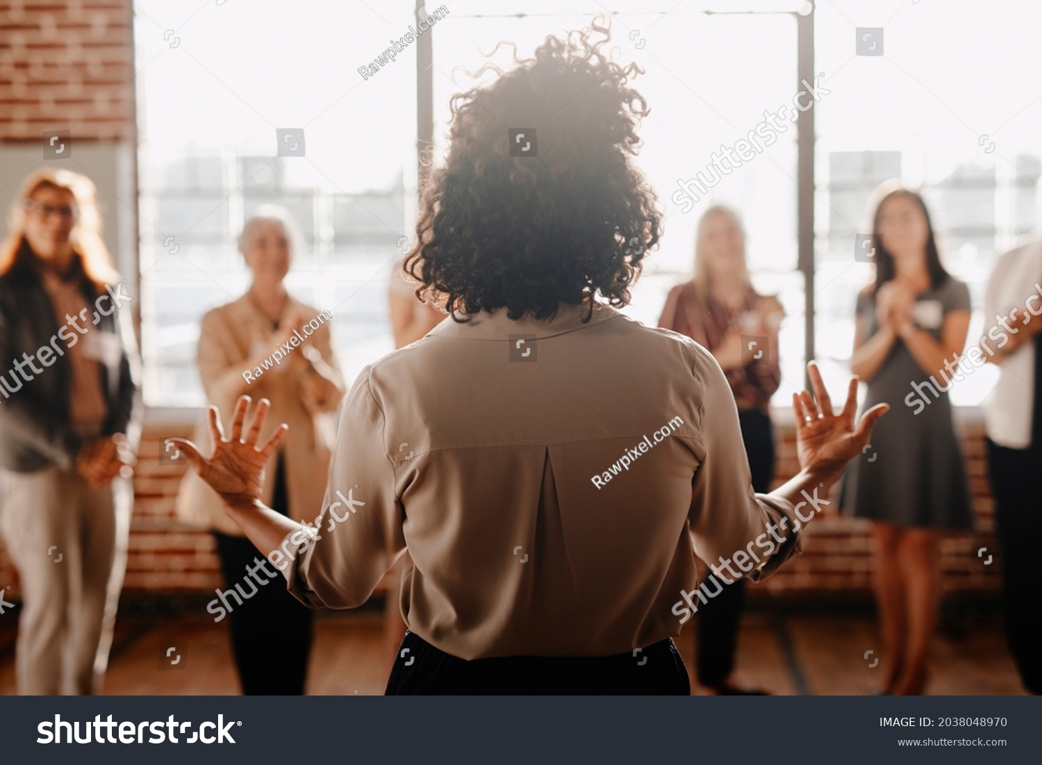 African american female empowering other colleagues in workplace #2038048970