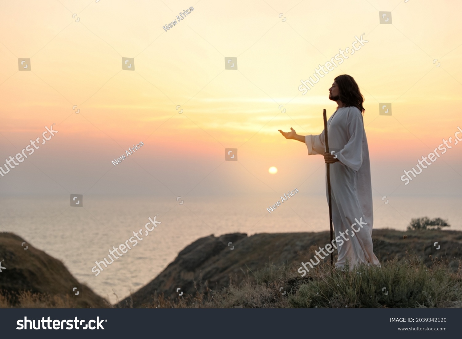 Jesus Christ on hills at sunset. Space for text #2039342120