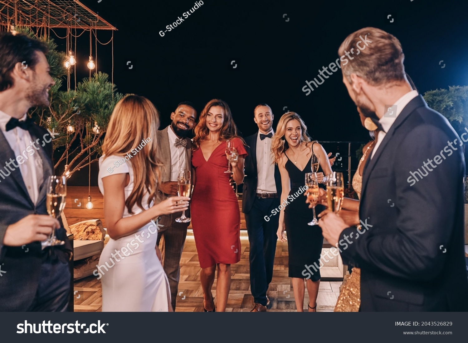 Group of beautiful people in formalwear communicating and smiling while spending time on luxury party #2043526829