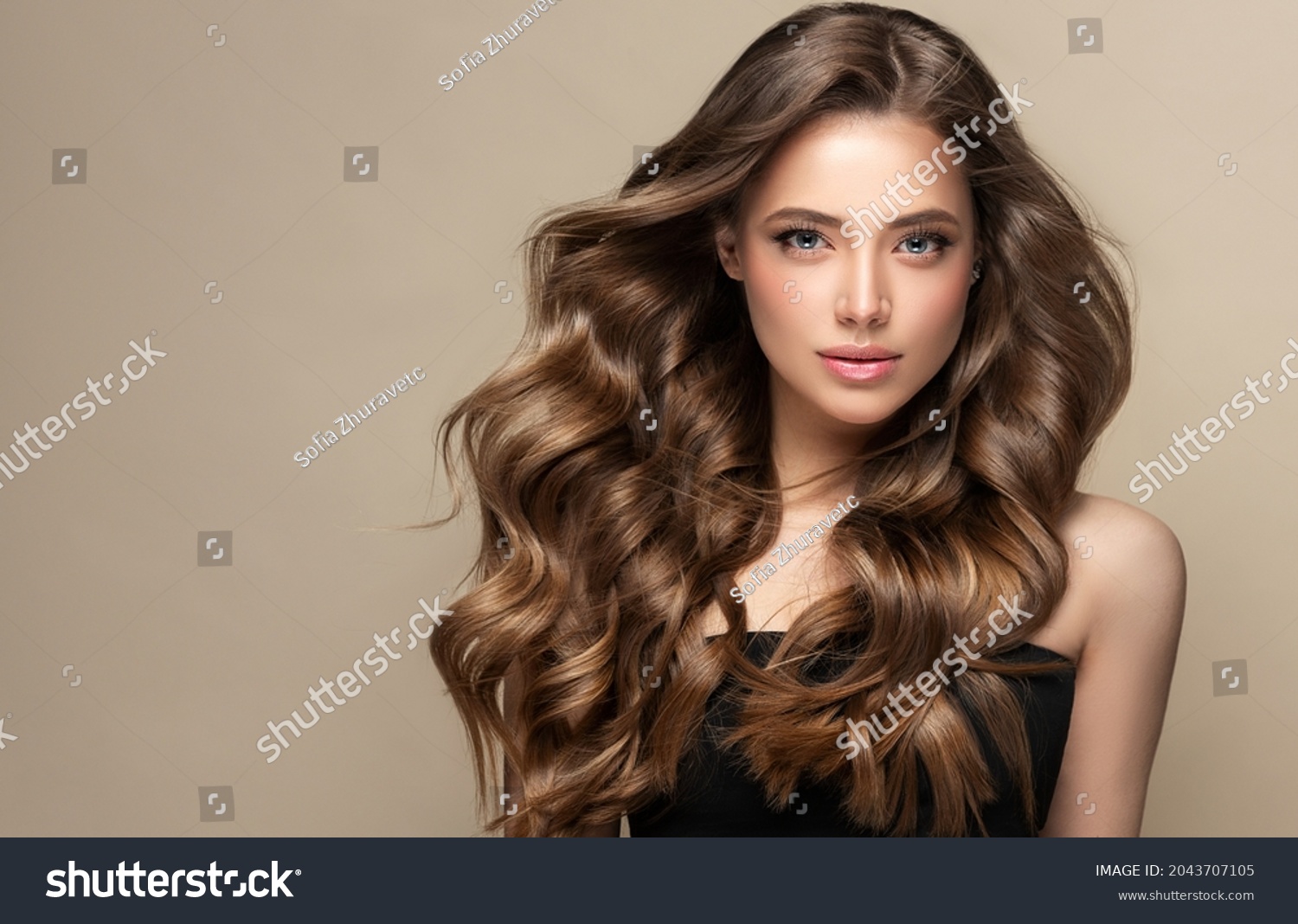 Beautiful laughing brunette model  girl  with long curly  hair . Smiling  woman hairstyle wavy curls .     Fashion , beauty and makeup portrait
 #2043707105