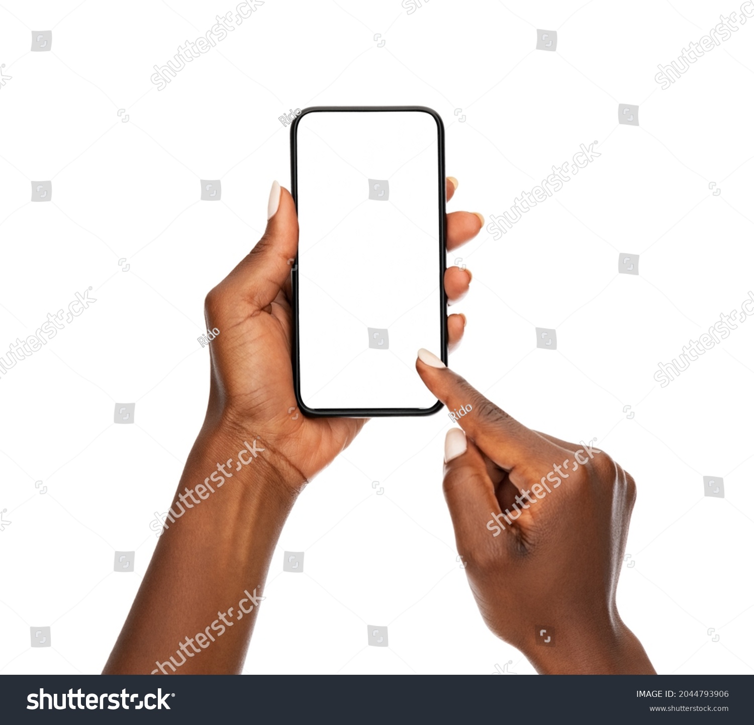 Close up hands of woman showing smartphone against white background. African woman hands touching blank screen of cellphone over white wall. Close up hands using app on mobile phone. #2044793906