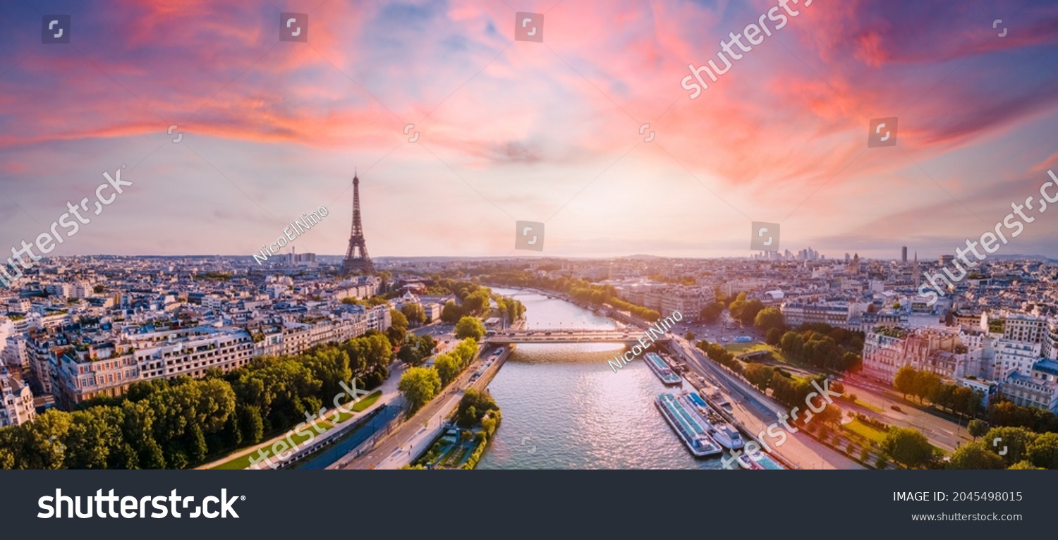 Paris aerial panorama with river Seine and Eiffel tower, France. Romantic summer holidays vacation destination. Panoramic view above historical Parisian buildings and landmarks with sunset sky #2045498015