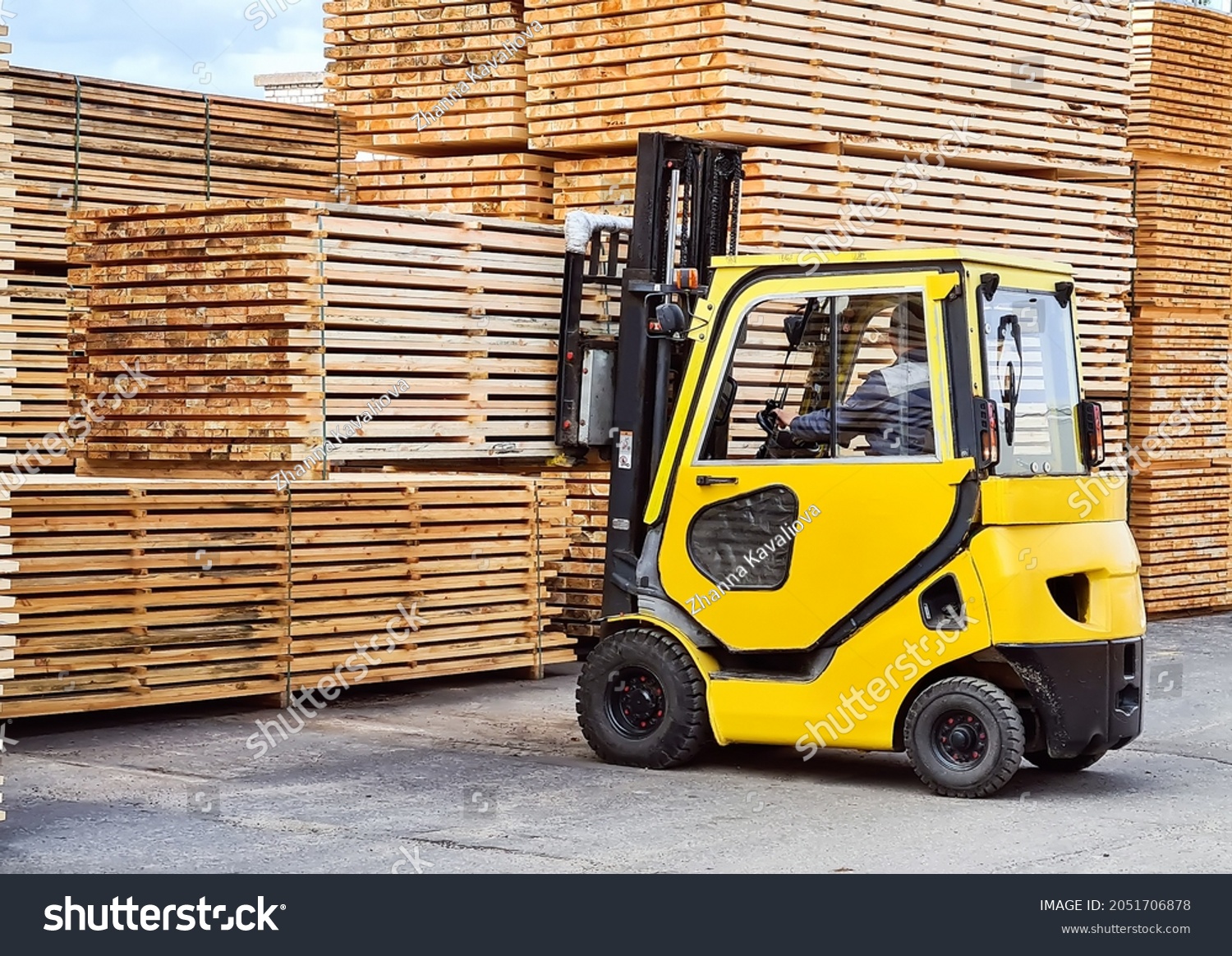 Forklift loads lumber into stacks at the finished product warehouse #2051706878