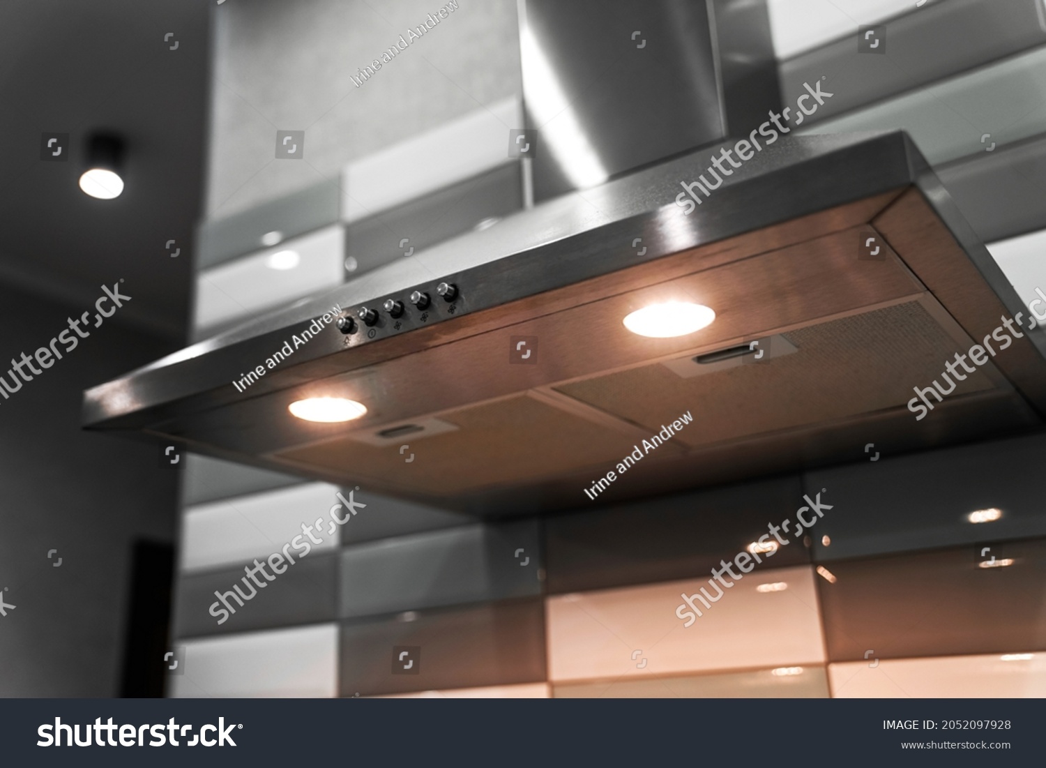  kitchen metal hood with illumination close-up. extractor hood in the restaurant. electrical equipment for the kitchen                            #2052097928