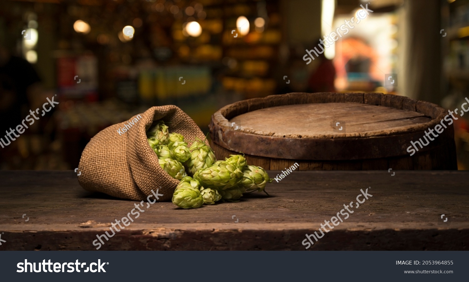 Hop twig over old wooden table background. Vintage style. Beer production ingredient. Brewery. Fresh-picked whole hops close-up. Brewing concept wallpaper. #2053964855