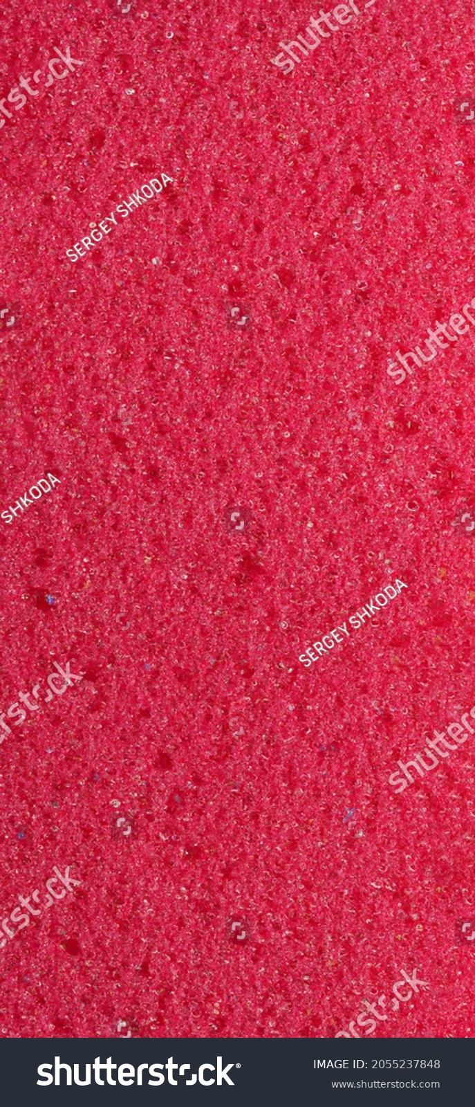 close-up, background, texture, large long vertical banner. heterogeneous surface fine pore structure bright saturated red pumice stone for finger care. full depth of field. high resolution photo #2055237848