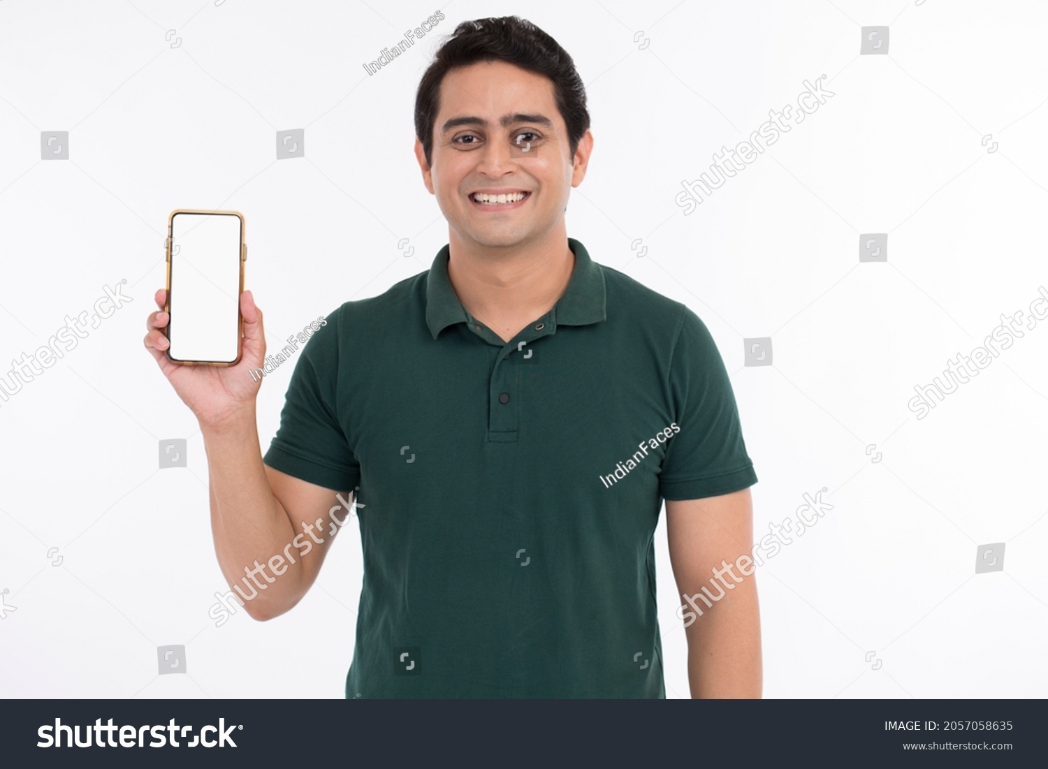 Attractive cheerful young man showing mobile phone. #2057058635