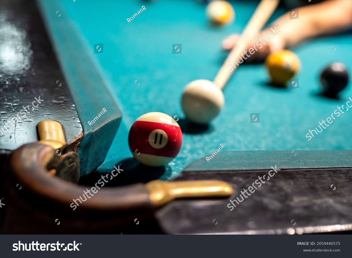 close up of female hand hold cue and preparing aiming to shoot to pool balls. game concept #2059440575