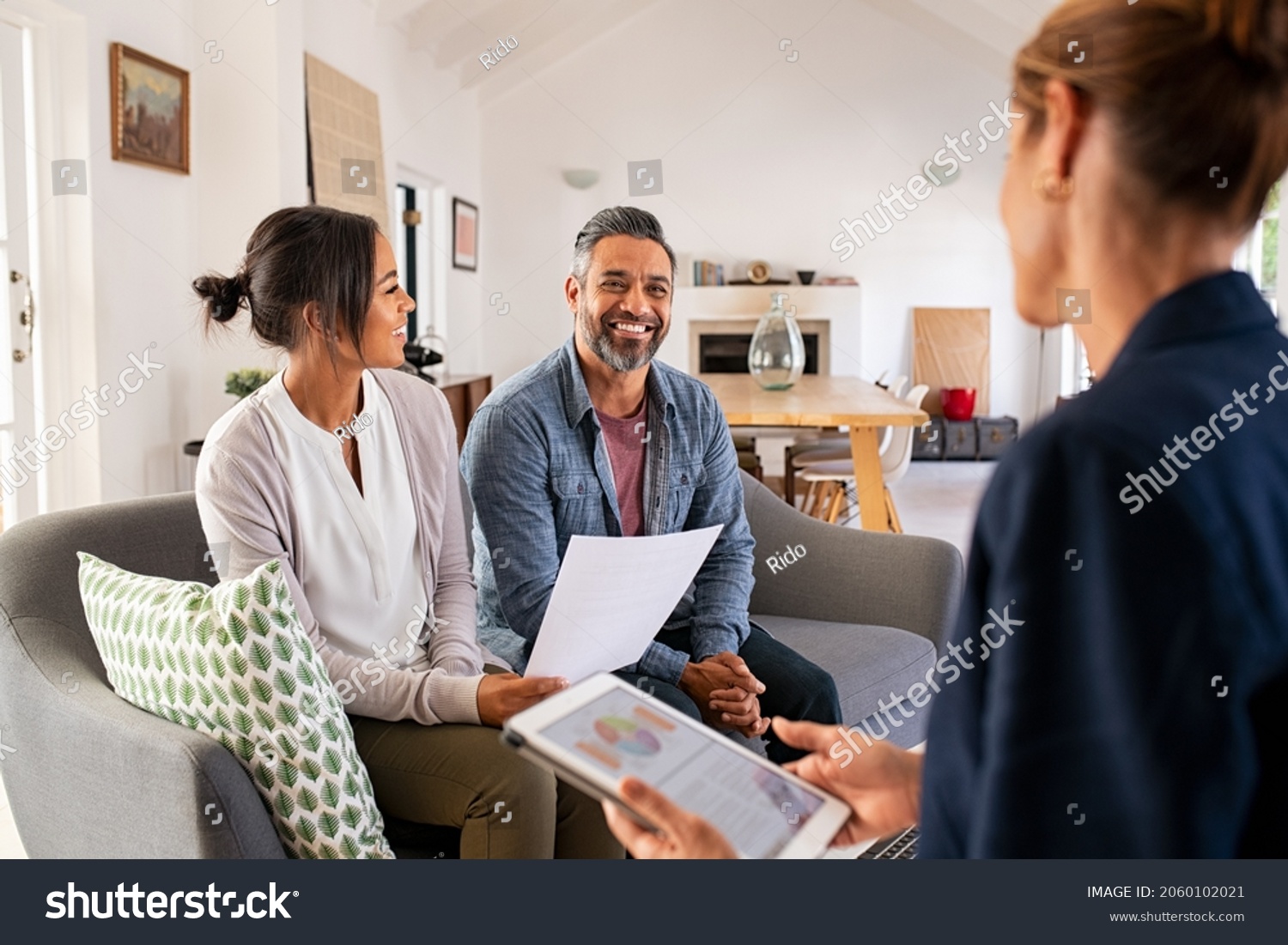 Happy mature couple discussing investments with financial broker during meeting at home. Middle eastern man and woman discussing about financial planning with consultant at home. Financial consultant  #2060102021