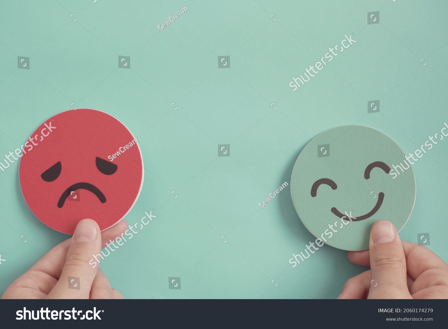 Hands holding happy and angry face paper, feedback rating , customer review, Emotional intelligence, balance emotion control,mental health assessment, bipolar disorder concept #2060174279