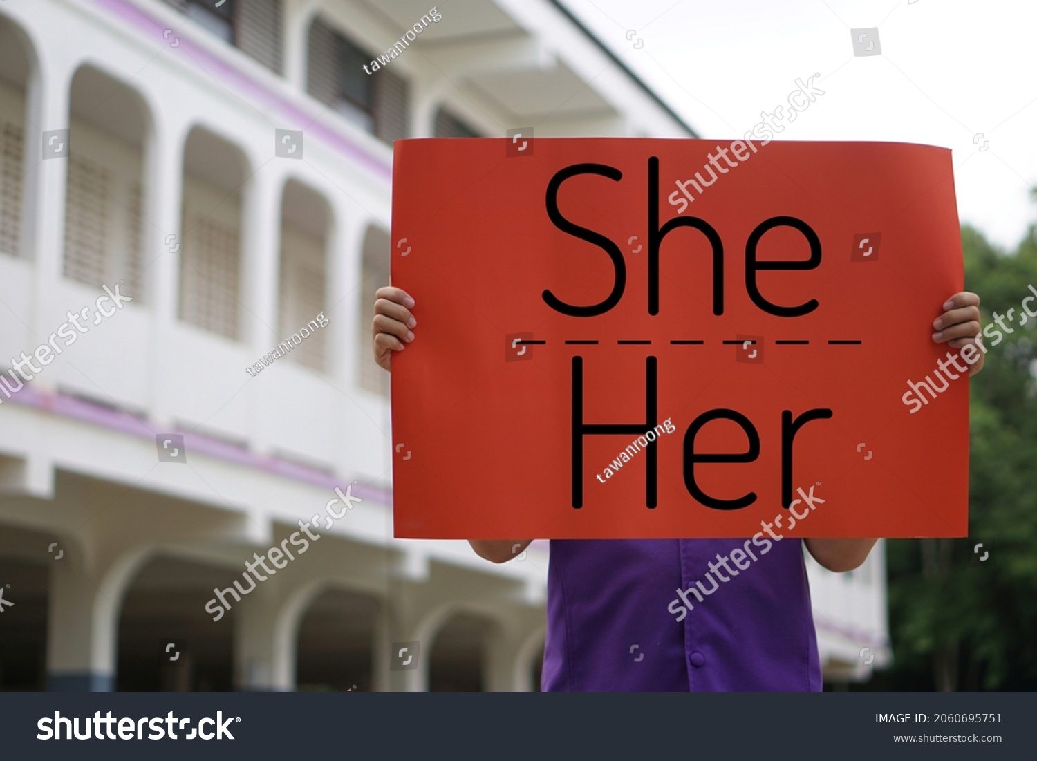 Concept : English grammar, subject and object pronouns teaching. Word " She- Her" on red paper sign held by a student at school. Word card for education. Teaching material. Personal pronouns. #2060695751