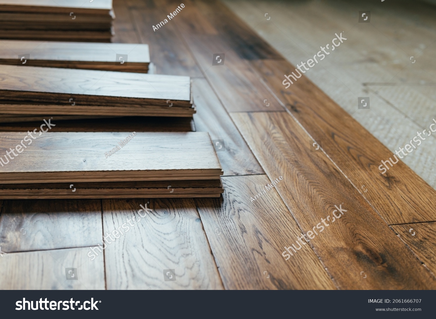 The process of house renovation with changing of the floor from carpets to solid oak wood. Beautiful golden handscraped oiled European oak brushed for added texture and fine definition of wood grain #2061666707
