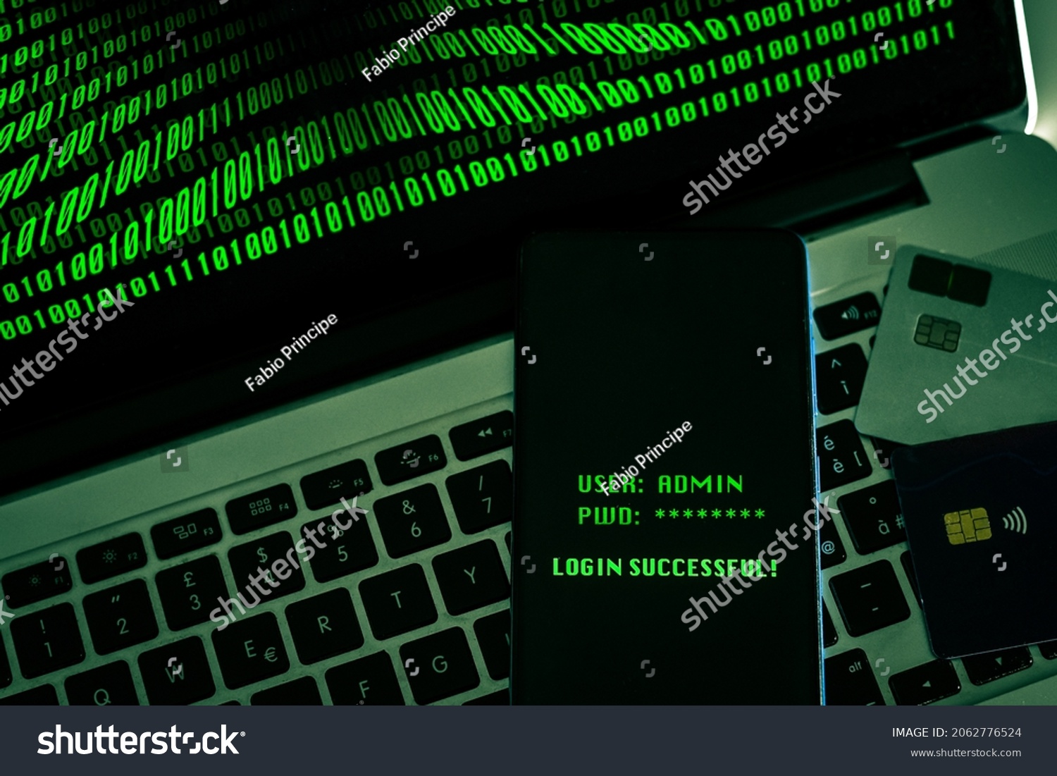 Laptop with green numbers on display. Credit cards, smartphone displaying successful login with credentials user and password. Remote banking technology, security privacy, hacker, cyber crime concept #2062776524