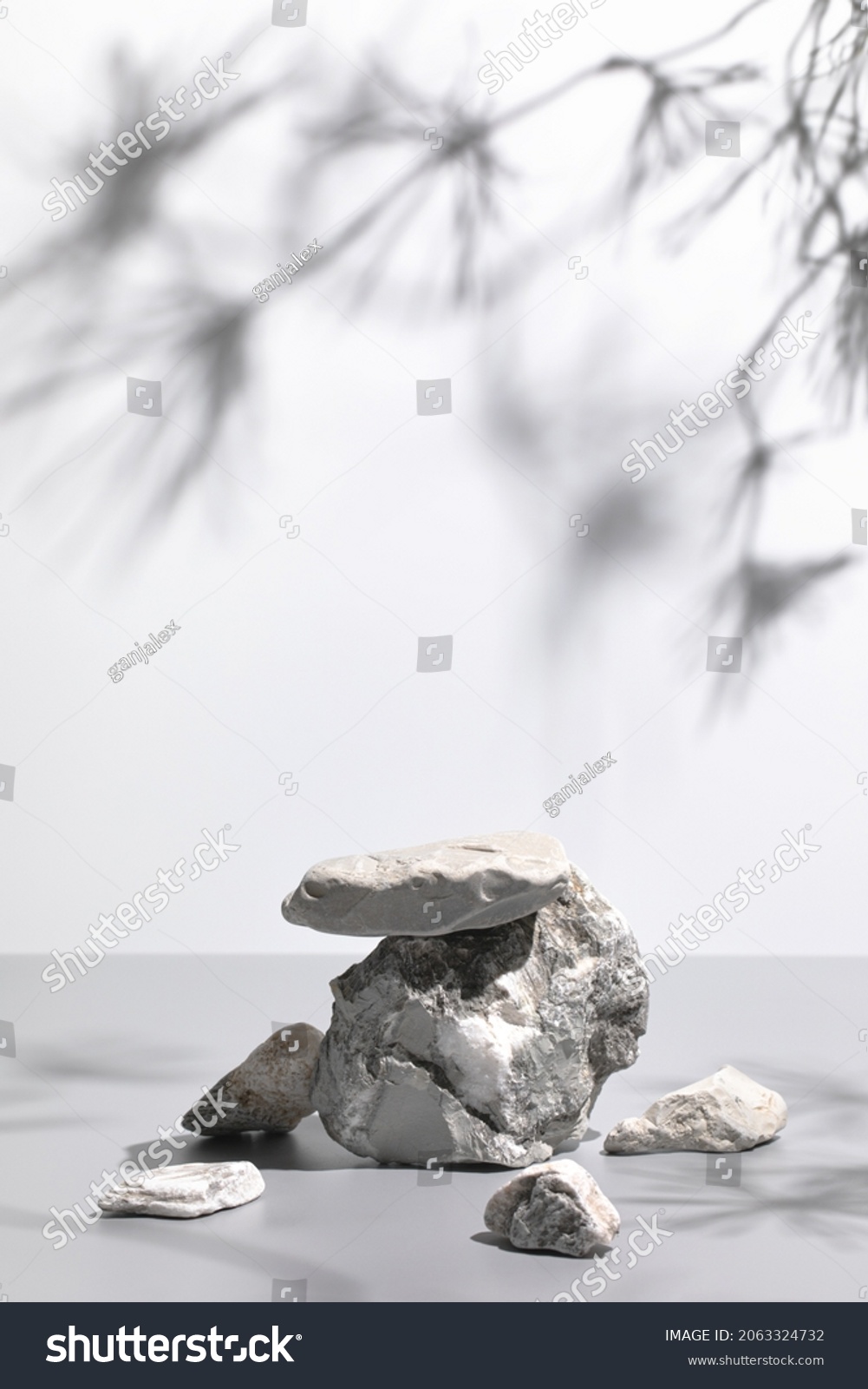 Abstract nature scene with composition of gray stones and pine tree leaves shadows. Neutral background with podium for cosmetic or beauty product, branding, packaging mockups. Copy space, front view #2063324732