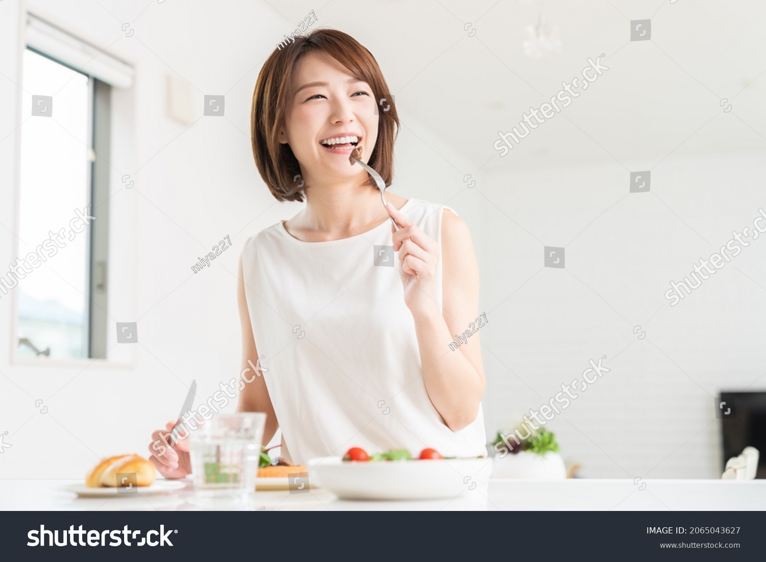 young attractive asian woman who eats #2065043627