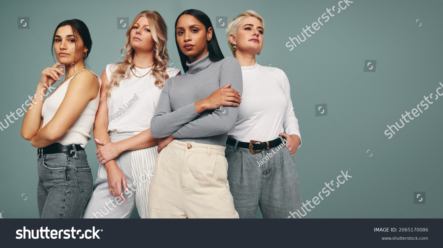 Style and confidence. Diverse group of empowered women standing together against a studio background. Self-confident female friends standing in a studio. #2065170086