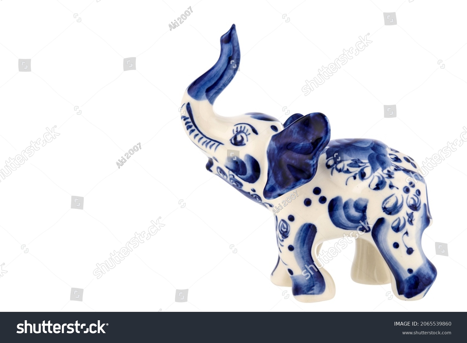 Cute Elephant Figurine Sculpture Porcelain Ceramic Isolated on white background. Cobalt Blue color is traditional folk painting. Decor for interior of premises. #2065539860