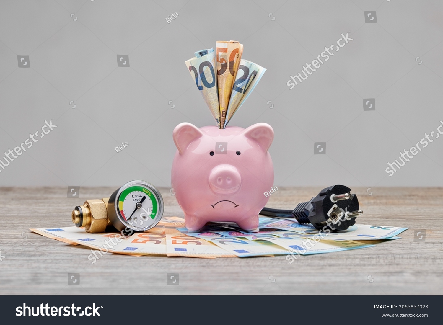 Sad piggybank for high cost of gas, electricity and power. Inflation is increasing everywhere, especially for gas and electricity bills. Saving and spending money due to power crisis. #2065857023