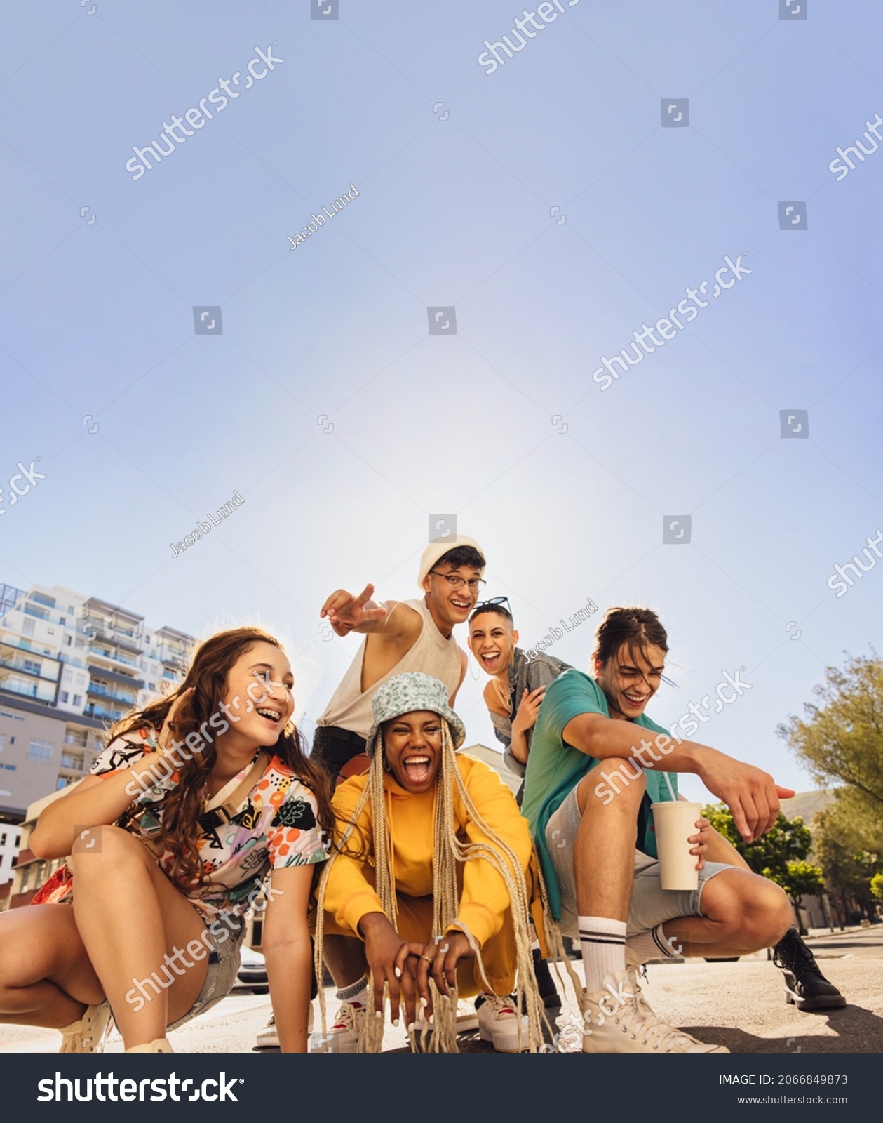 Diverse group of friends having fun in the city. Group of multiethnic generation z friends enjoying spending time together. Cheerful young friends making happy memories together outdoors. #2066849873