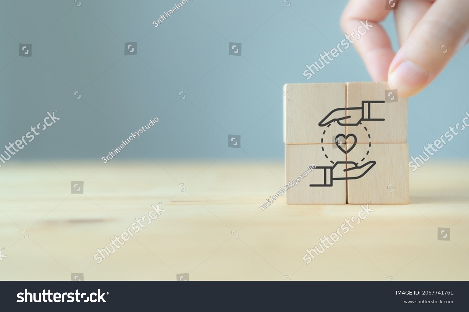 Customer relationship management (CRM) or customer loyalty concept. Customer satisfaction, retention strategies. CRM or customer loyalty program banner. Hand put wooden cubes with holding heart icon. #2067741761