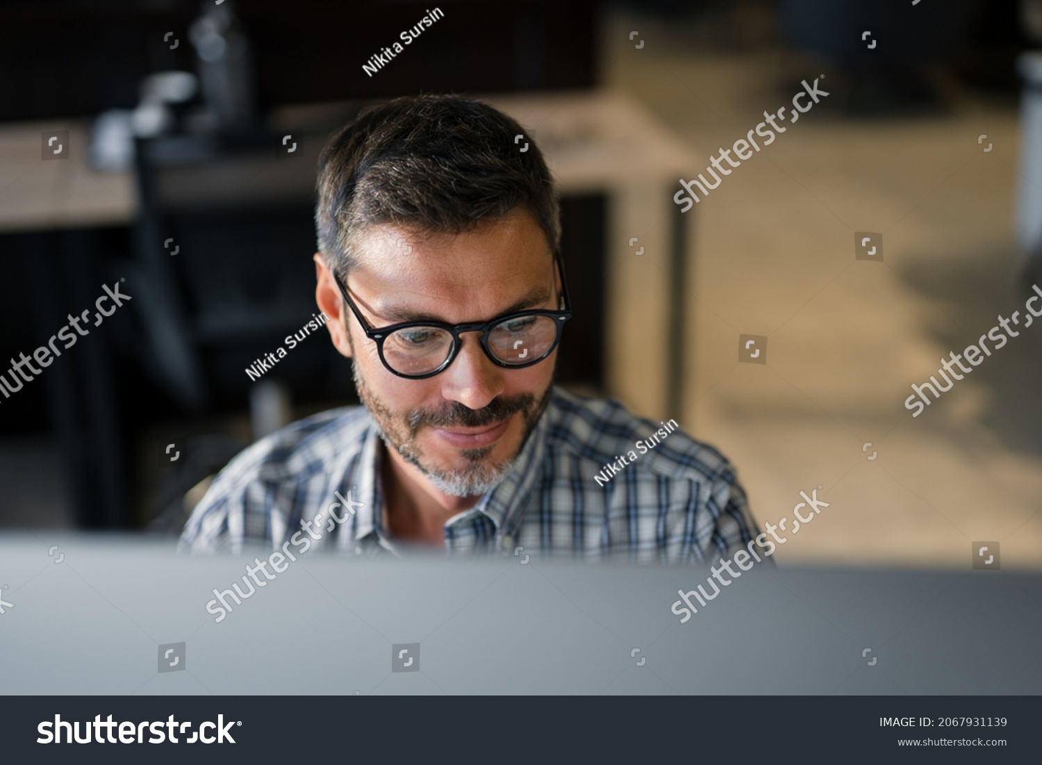 Close Up Young Man in Fashion Glasses Eye Looking Monitor, Surfing Internet. Stylish Male Working With computer From Home in Him Home Office. The Monitor Screen Is Reflected In The Glases
 #2067931139