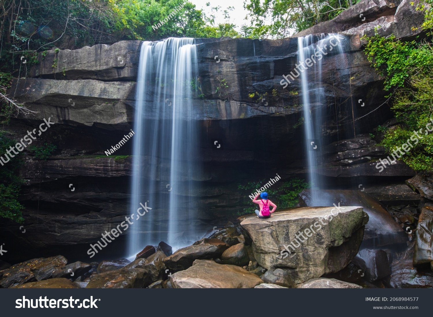 Young woman hiking in Thung Na Muang Waterfall, Beautiful waterfall in Pha Tam national Park, Ubon Ratchathani  province, ThaiLand. #2068984577