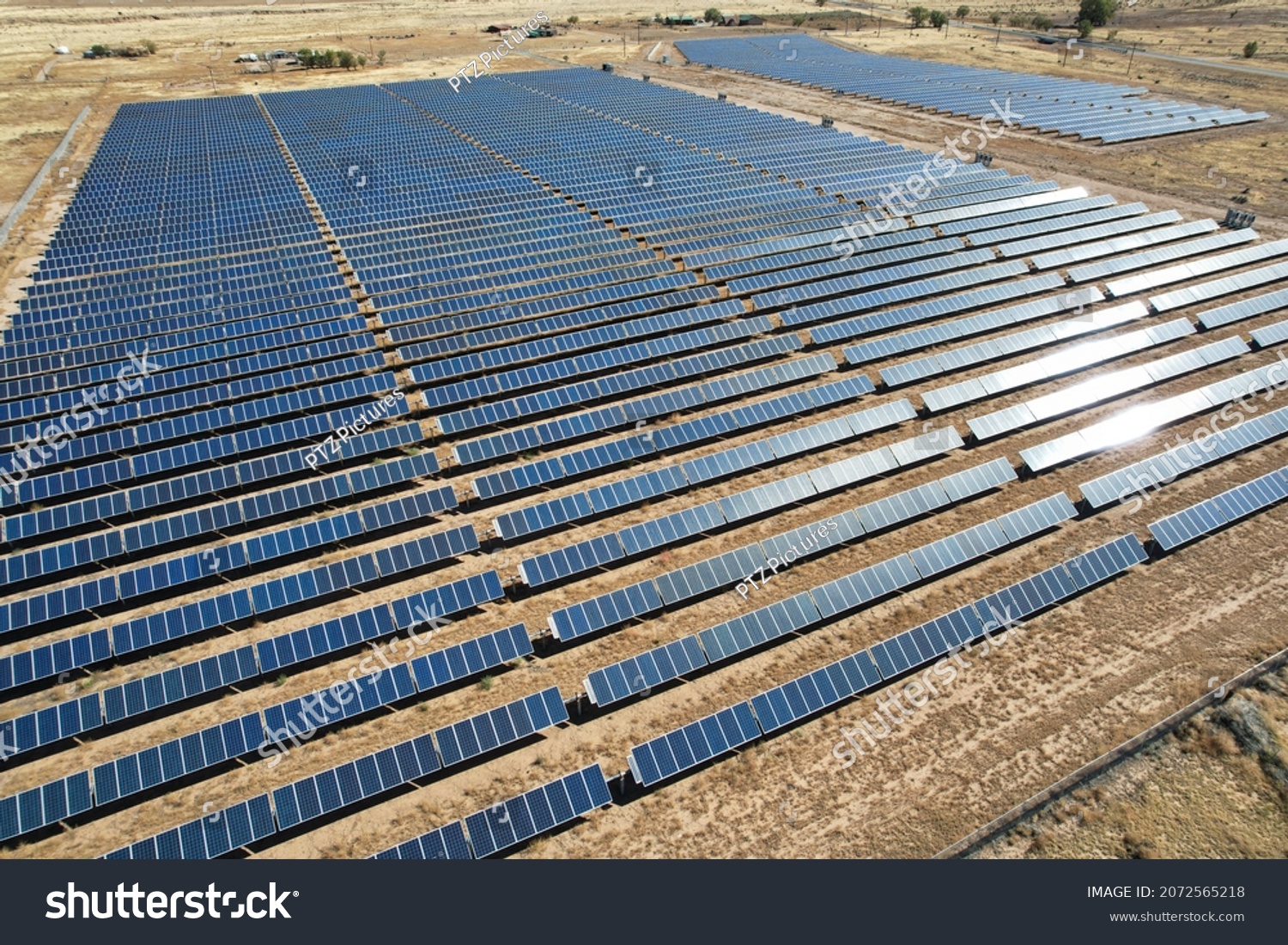 Aerial View of a Large Solar Array in the Desert #2072565218