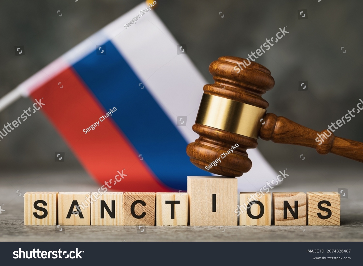 judge's gavel, wooden cubes with the text on the background of the Russian flag, the concept on the topic of sanctions in Russia #2074326487
