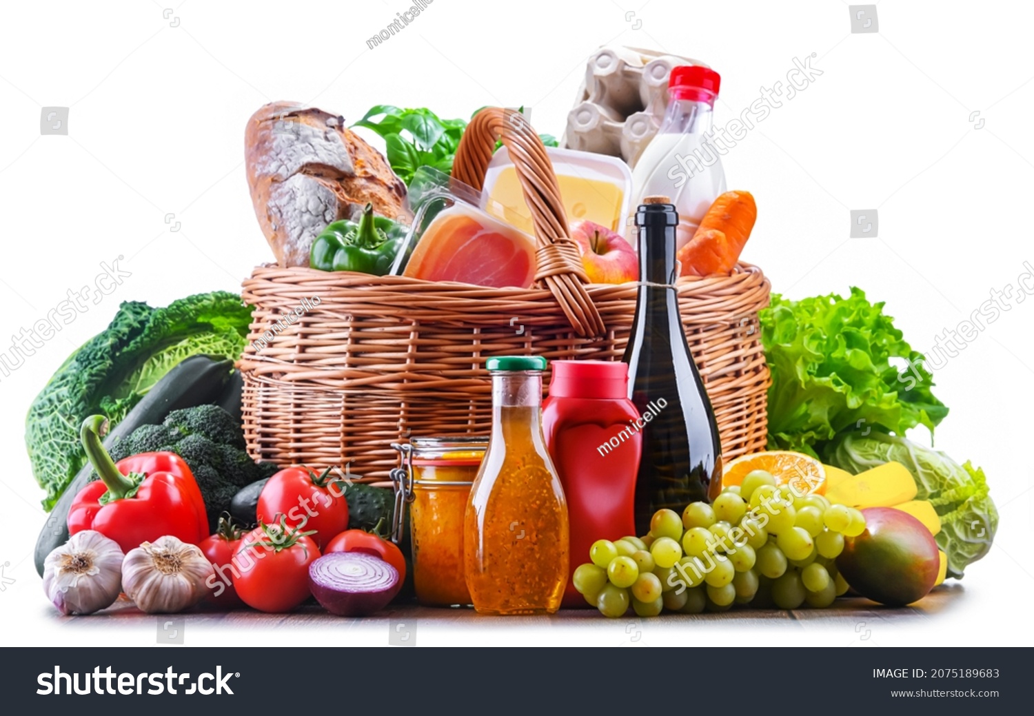 Wicker basket with assorted grocery products including fresh vegetables and fruits #2075189683