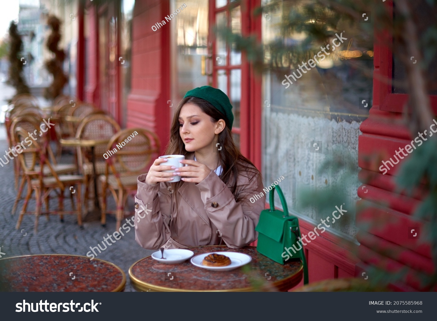romantic sophisticated woman drinking coffee or cappuccino in a french cafe on street. romantic sophisticated girl sits at a table in pastry shop or bakery #2075585968
