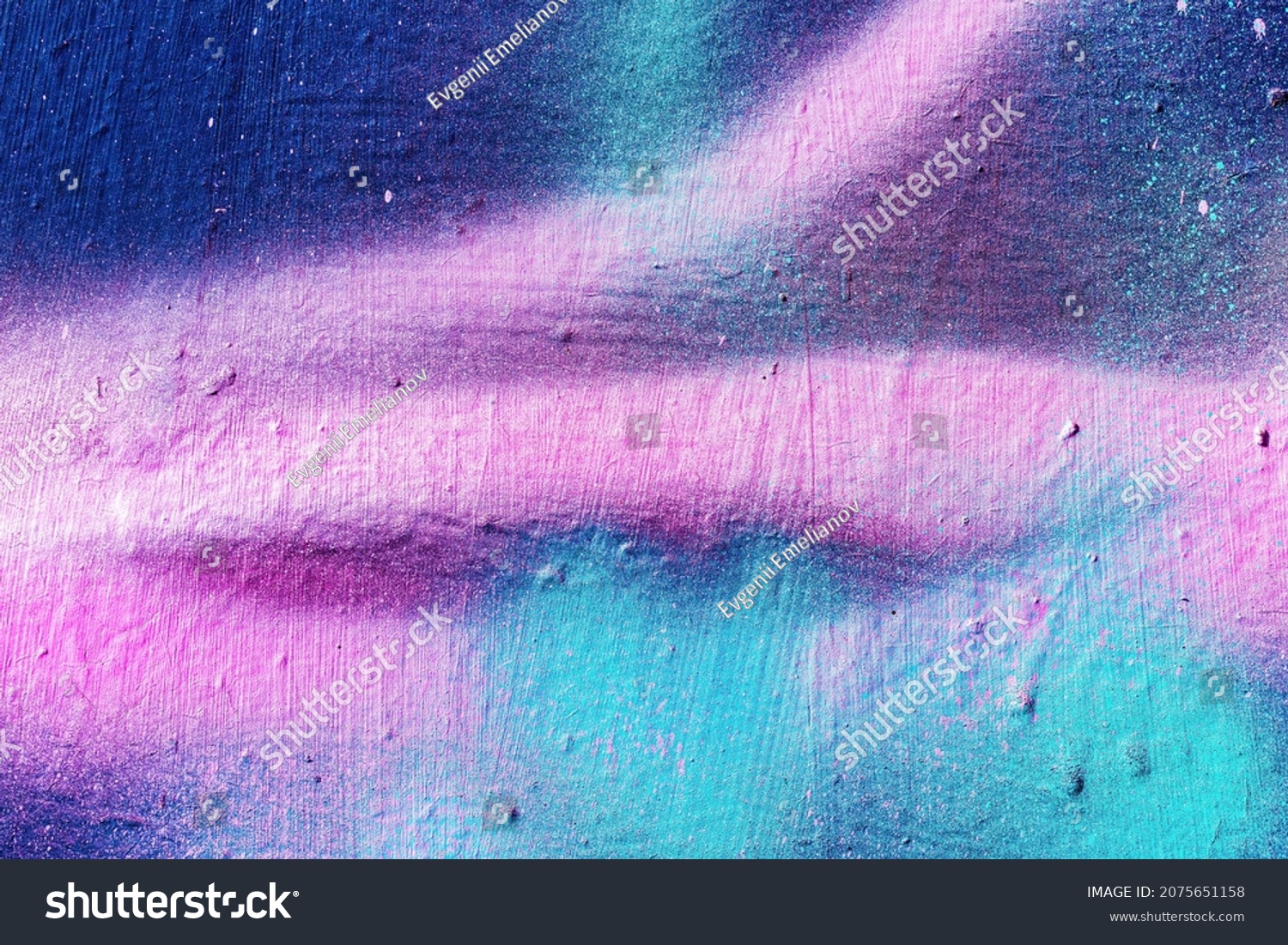 A fragment of colorful graffiti painted on a wall. Abstract urban background for design. #2075651158