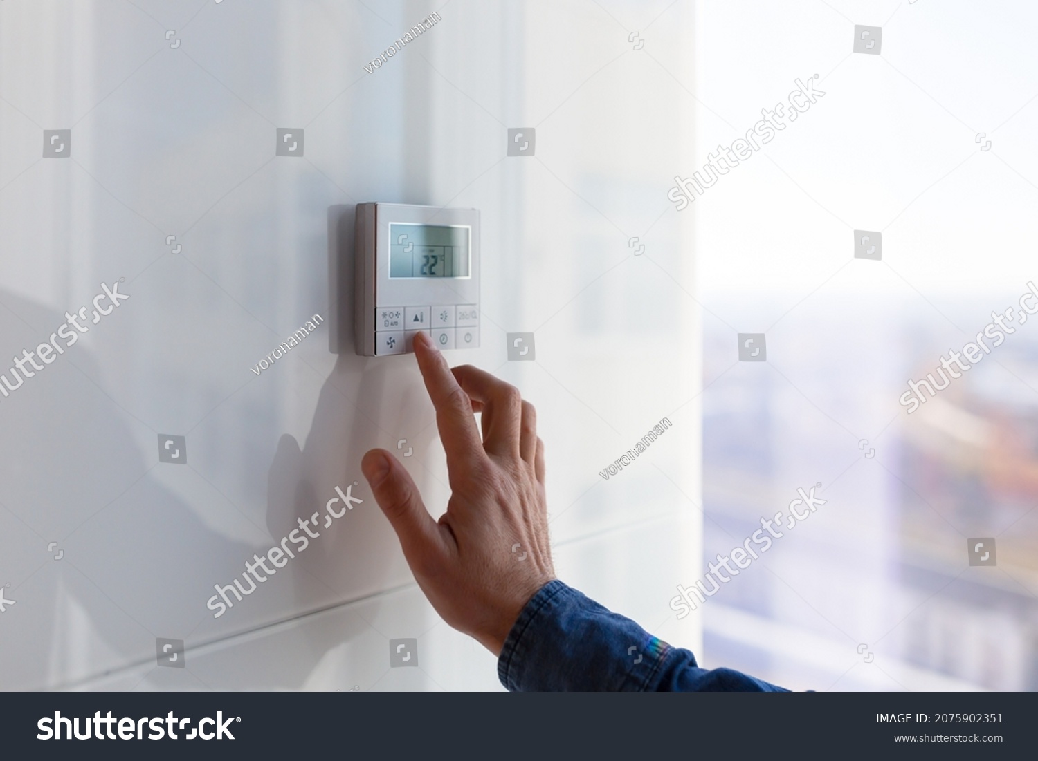 The air conditioning and heating control panel for the apartment and office is located on a white wall #2075902351