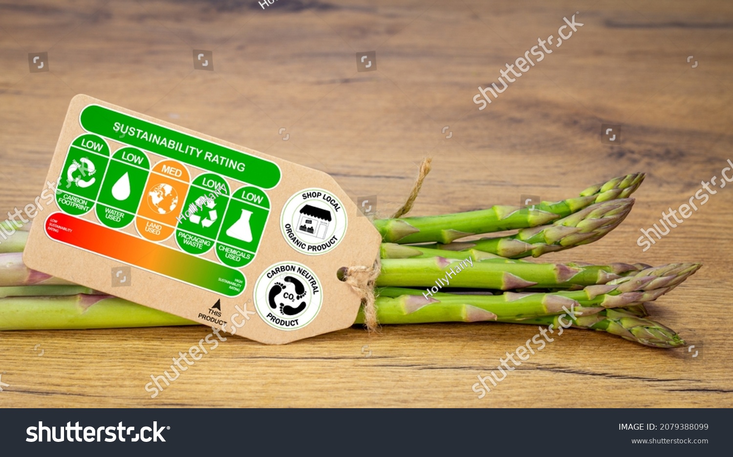 Sustainability rating label on organic asparagus with rating gradient for the product, carbon neutral and shop local labels, sustainable food concept #2079388099