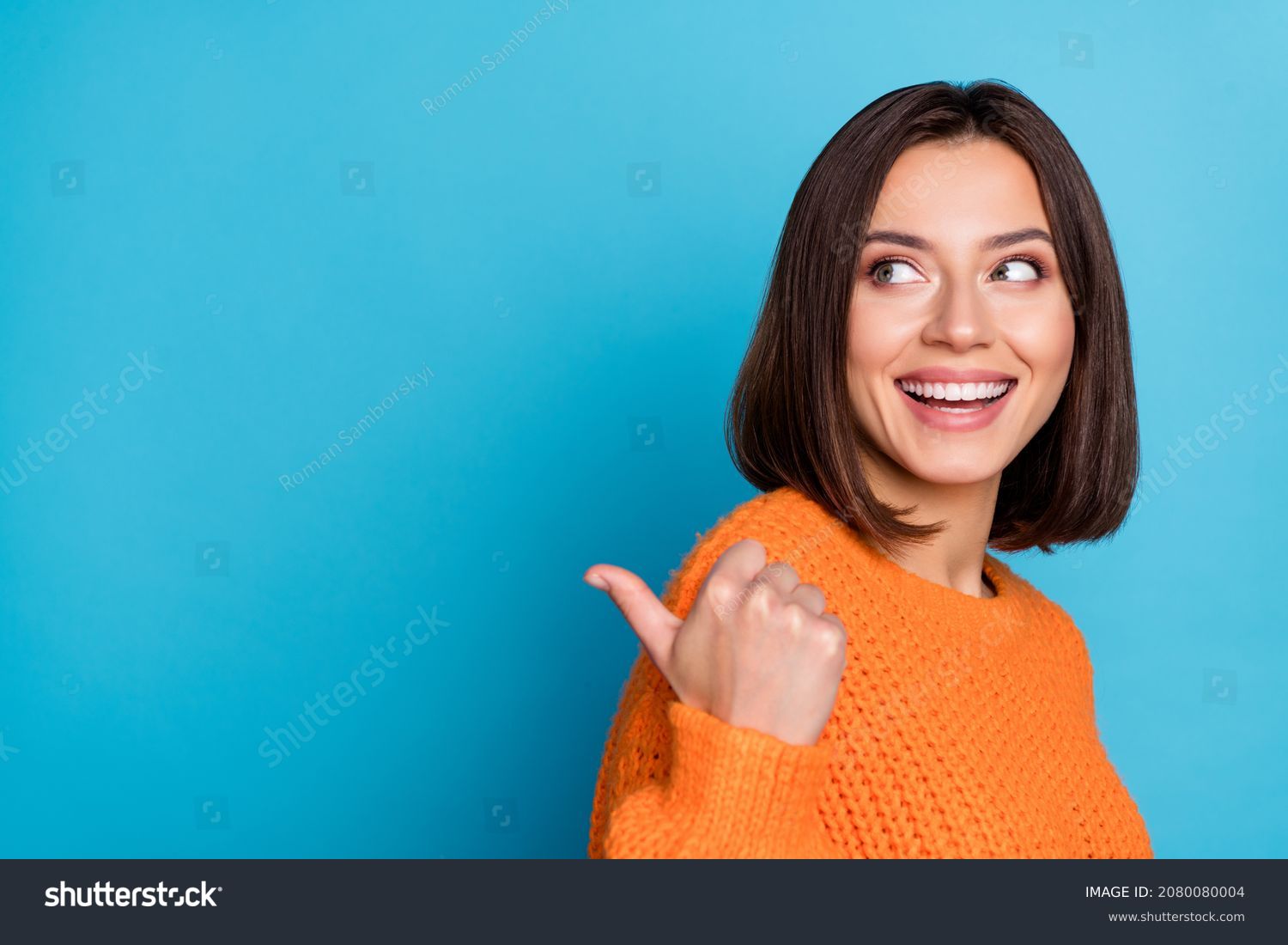 Profile side view portrait of attractive cheerful girl demonstrating copy space ad new isolated over bright blue color background #2080080004