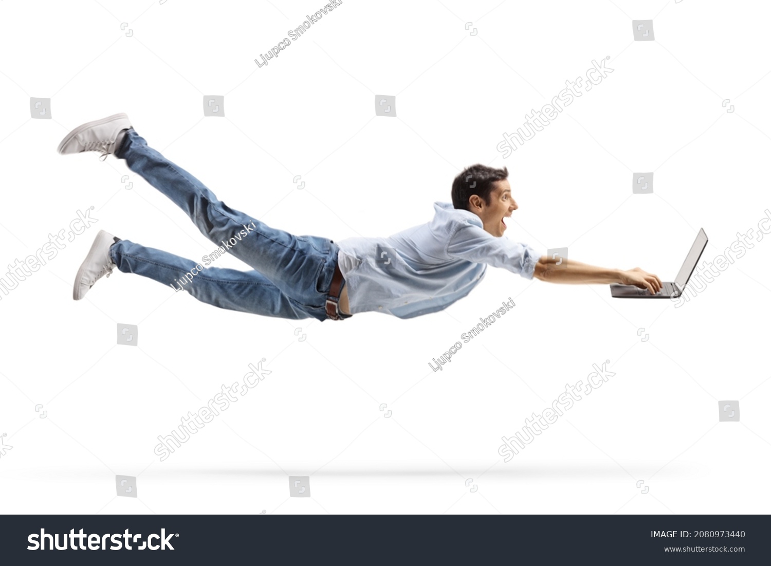 Young casual man flying and working on a laptop computer isolated on white background #2080973440