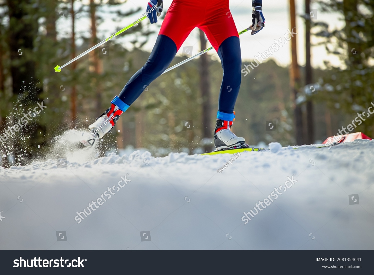 male skier athlete goes uphill on cross-country skiing #2081354041