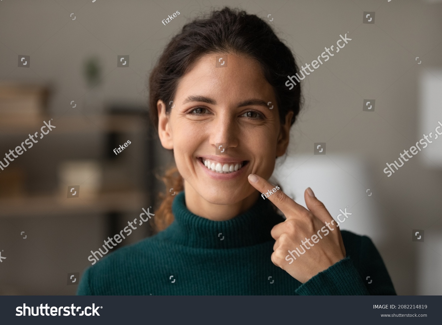 Shiny smile. Portrait of young happy hispanic woman satisfied patient of dental clinic. Millennial lady enjoy perfect result of orthodontic care procedures look at camera point on white straight teeth #2082214819