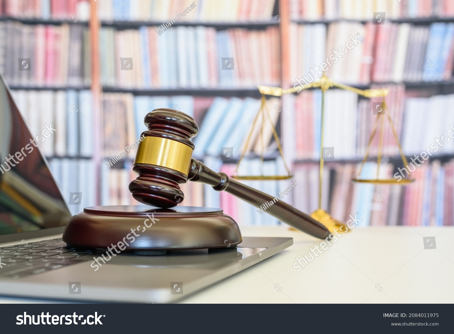 Legal office of lawyers, justice and law concept : Judge gavel or a hammer and a base used by a judge person on a desk in a courtroom with blurred weight scale of justice. #2084011975