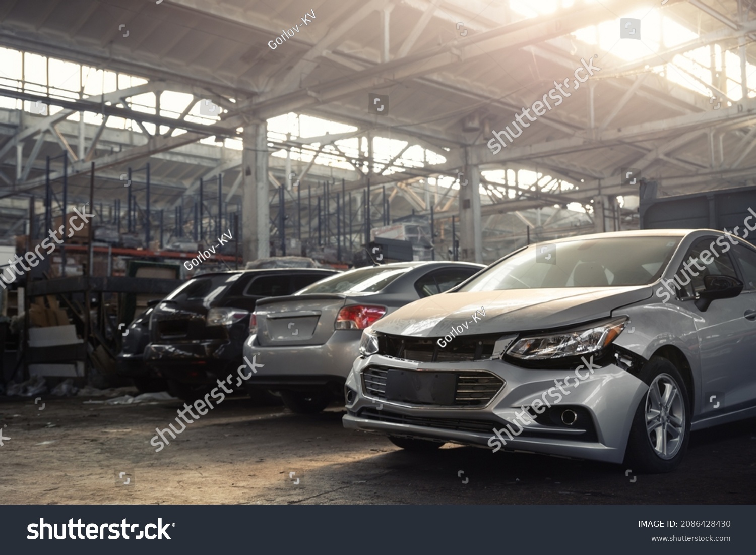 Many unknown altered wrecked car after traffic accident crash at restore service maintenance station garage indoor. Insurance salvage vehicle auction wholesale. Auto body wreck damage workshop center #2086428430