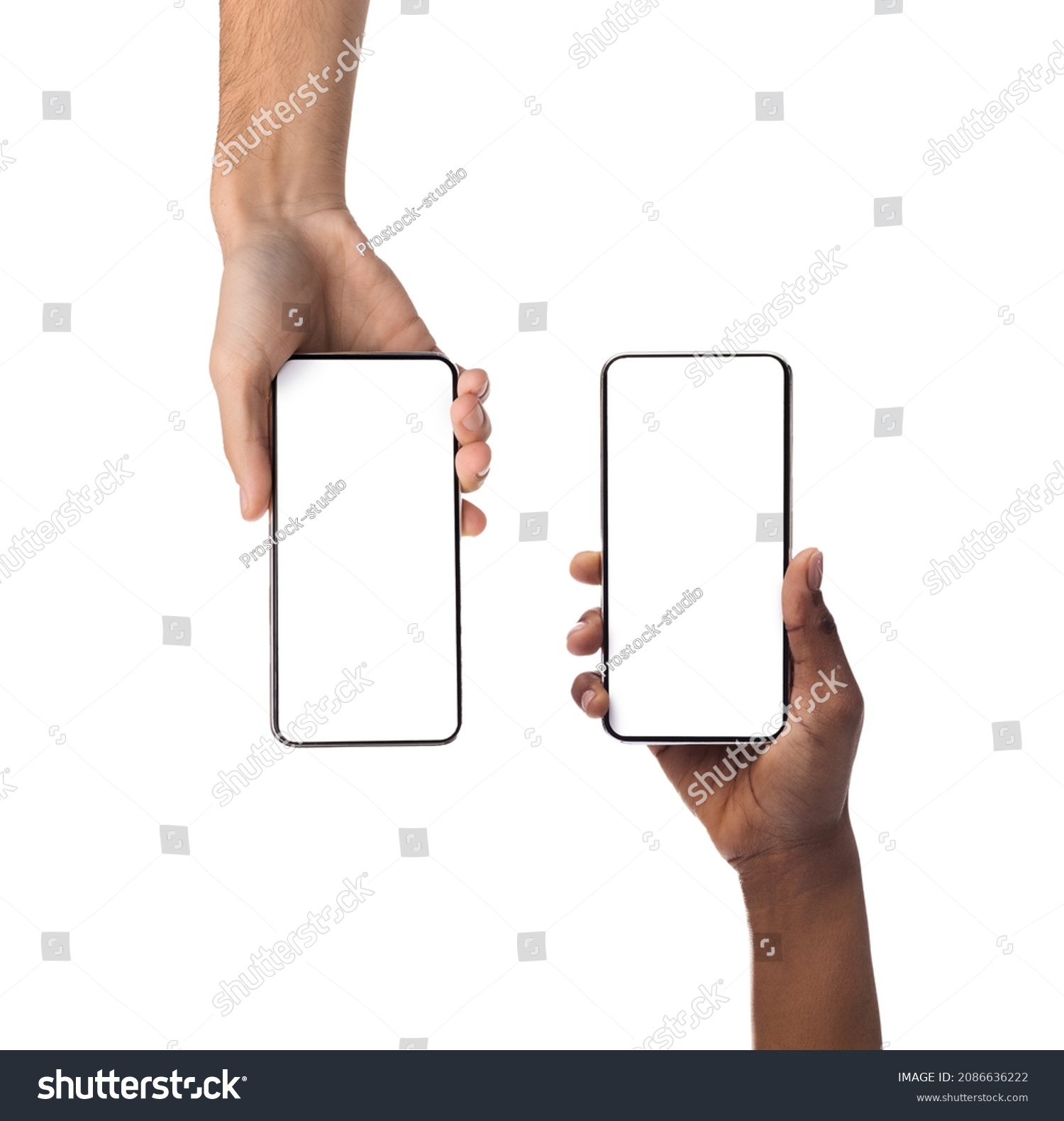 Closeup of female and male hands holding 2 smartphones with white empty screen, showing using devices, transfer data, sharing media. Two vertical gadgets with copy space, mock up, studio background #2086636222