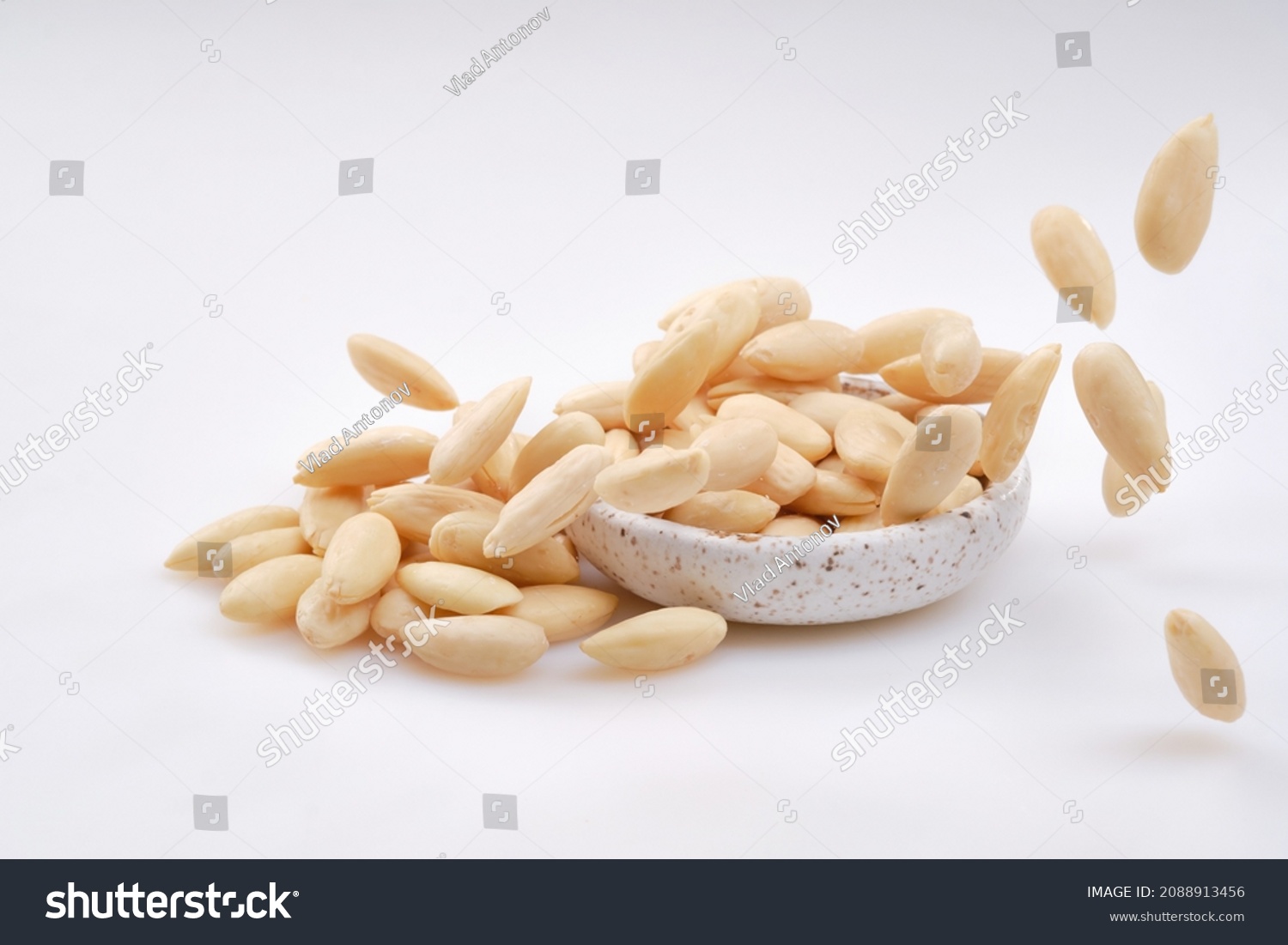 Pile of Peeled  Almonds. Falling Blanched Almonds. Healthy White Almond on White Background. Shallow depth of field #2088913456
