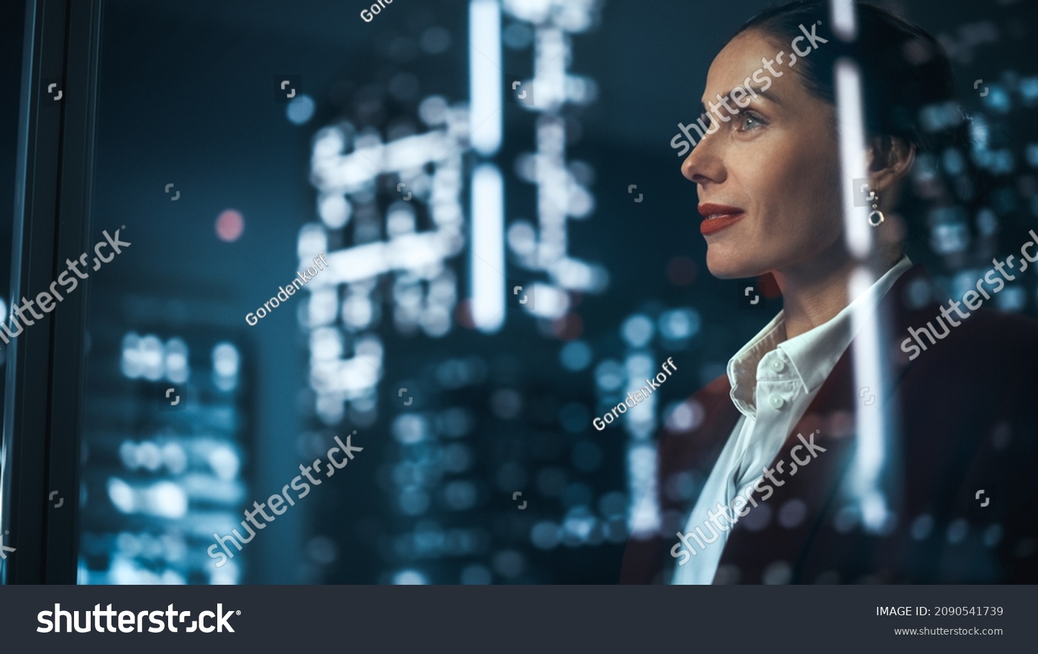 Successful Businesswoman in Stylish Suit Working on Top Floor Office Overlooking Night City. High Achievement Female CEO of Humanitarian Investment Fund, Human Face of Sustainable Corporate Governance #2090541739