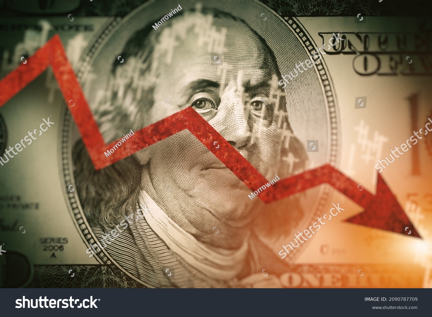 Closeup detail of  dollar bill.  Economist forecast for the United States. Glowing red arrow going downwards on Benjamin Franklin portrait on dollar bill.  Effect of recession on US economy. #2090787709
